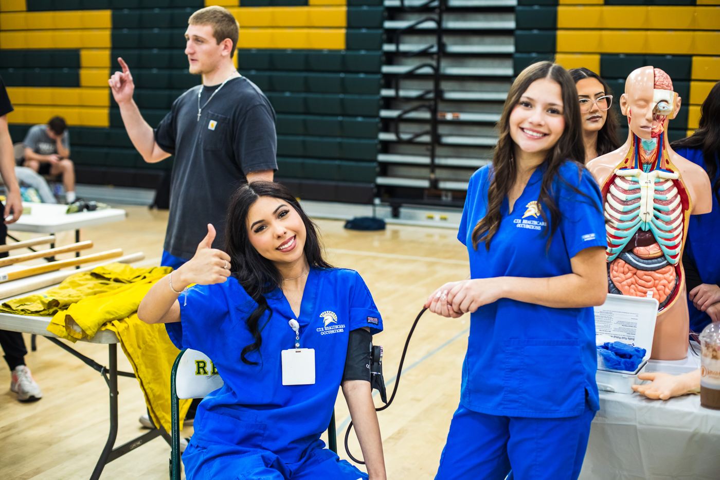 Students give a thumbs up at a school outreach event